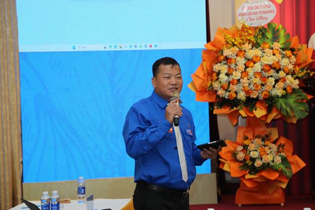 A person holding a microphone and holding a trophyAI-generated content may be incorrect.