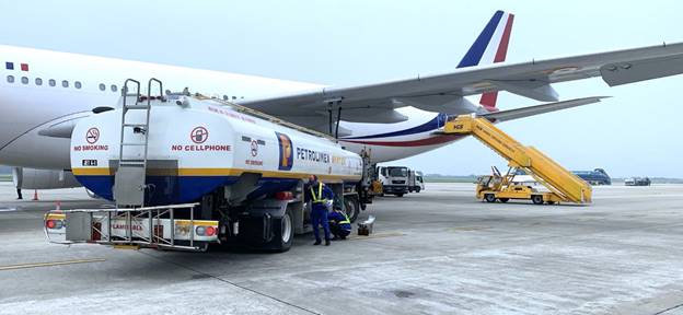 A large white airplane with a blue and red tail and a yellow ladderAI-generated content may be incorrect.
