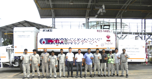 A group of men standing in front of a white truck