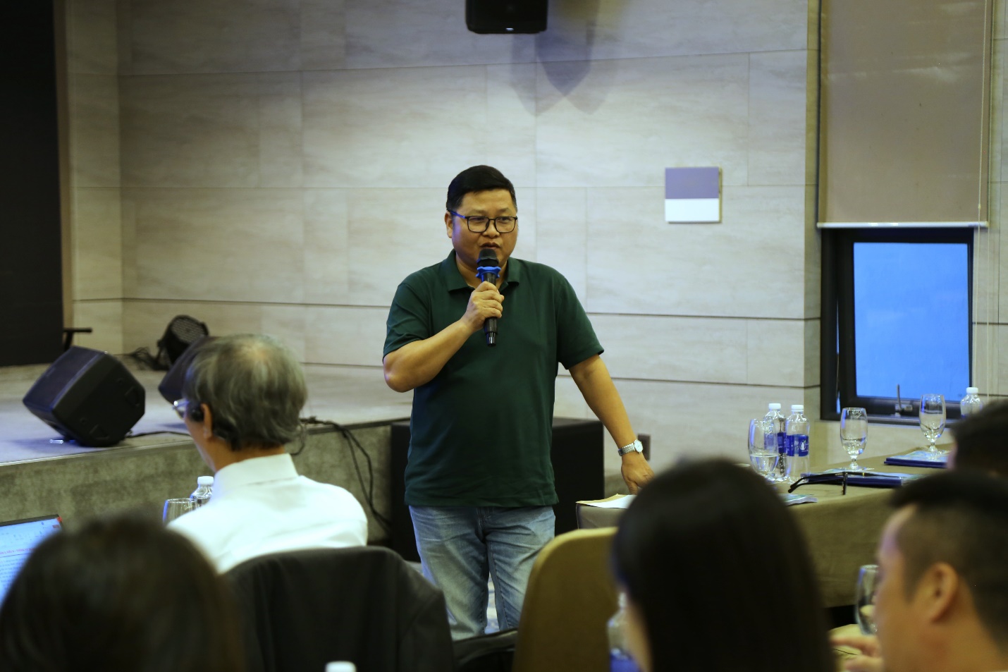 A person speaking into a microphoneAI-generated content may be incorrect.