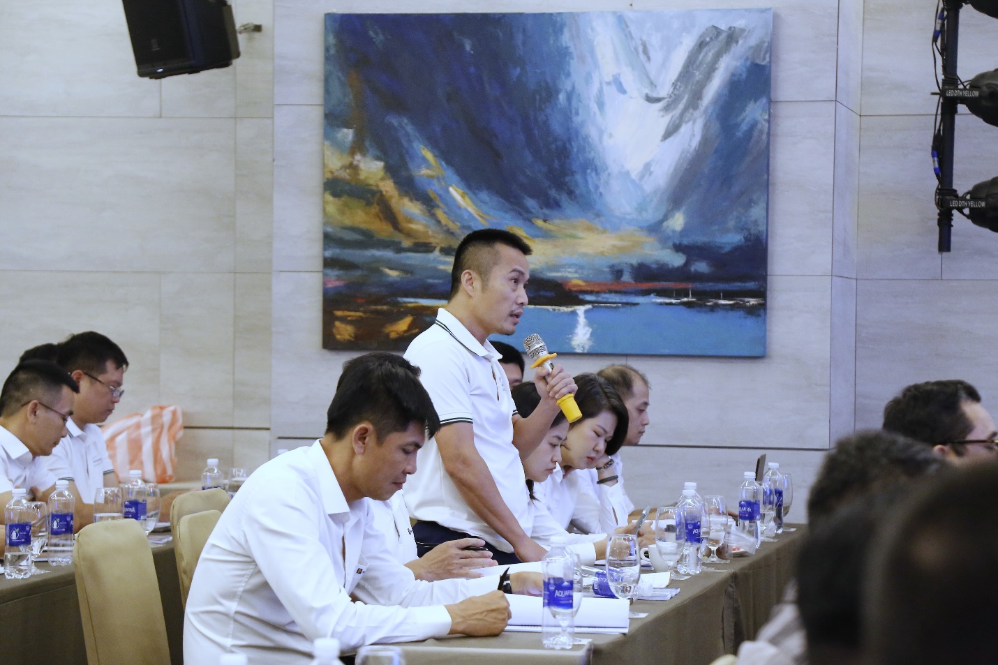 A group of people sitting at a tableAI-generated content may be incorrect.