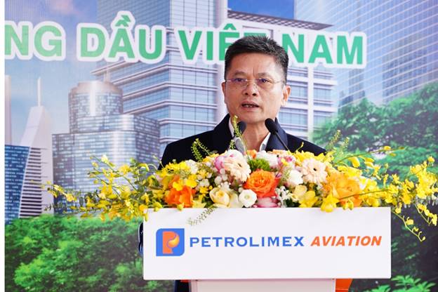 A person standing at a podium with flowersAI-generated content may be incorrect.