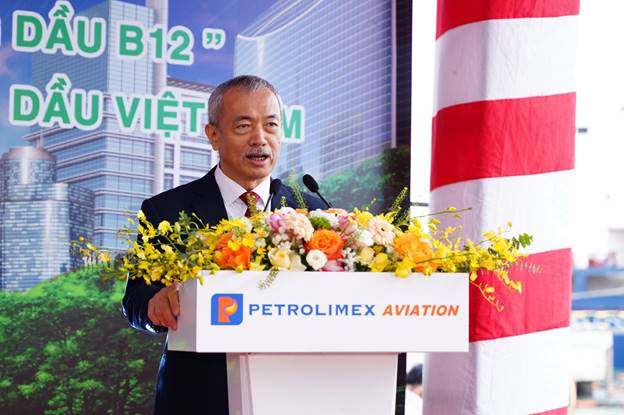 A person standing at a podium with flowersAI-generated content may be incorrect.