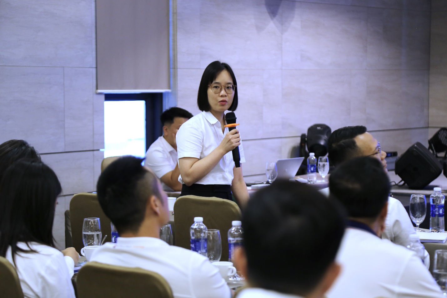 A person speaking into a microphoneAI-generated content may be incorrect.